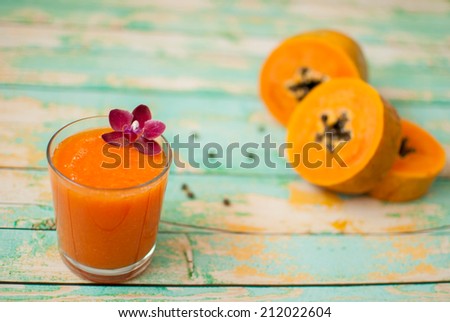 healthy fresh papaya smoothie juice on wooden green boards