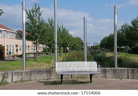 A design bench and lantern in rustproof stainless street furniture in a dutch community