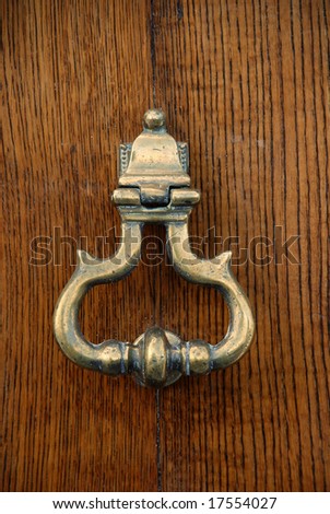 Copper door knocker on an oak door
