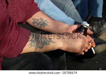 stock photo relaxed with a tattoo a cigarette and a beer