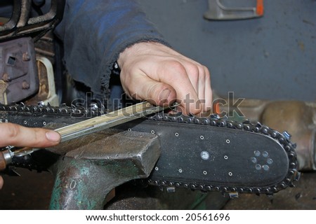 manual worker sharpening a chain saw
