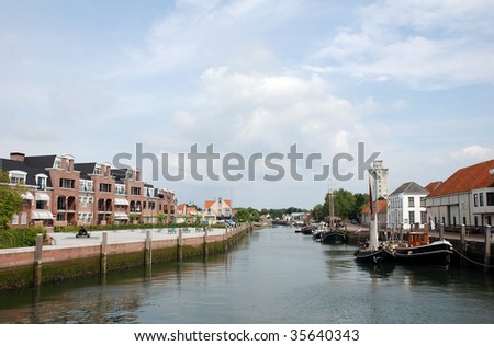 A development of new modern homes with view on the water is designed to fit in perfectly with the old historic homes in the dutch city Zierikzee