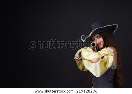 Girl pirate posing with musket