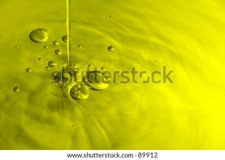 Pouring water with bubbles, olive oil yellow tone