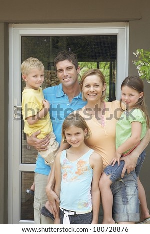 Happy family near their house