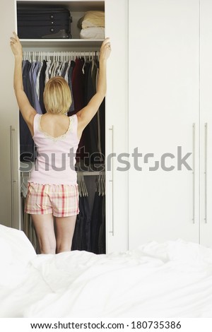 Nothing to wear concept, young woman deciding what to put on