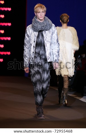 NEW YORK - FEBRUARY 13: Male model walks the wooden runway at the Custo Barcelona Fall 2011 Collection presentation during Mercedes-Benz Fashion Week on February 13, 2011 in New York.
