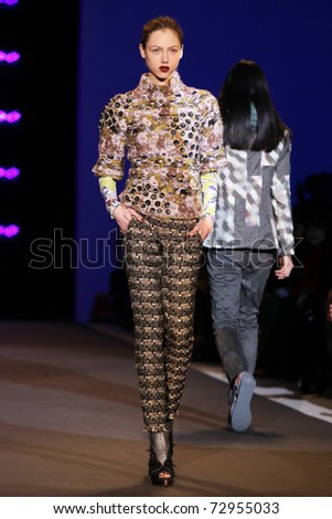 NEW YORK - FEBRUARY 13: Model walks the wooden runway at the Custo Barcelona Fall 2011 Collection presentation during Mercedes-Benz Fashion Week on February 13, 2011 in New York.