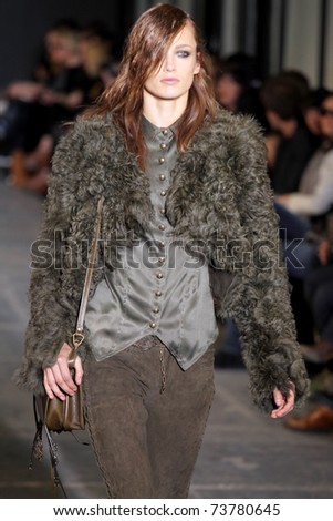 NEW YORK - FEBRUARY 15: Model Karmen Pedaru walks the wooden runway at the DIESEL BLACK GOLD  Fall 2011 Collection presentation during Mercedes-Benz Fashion Week on February 15, 2011 in New York.