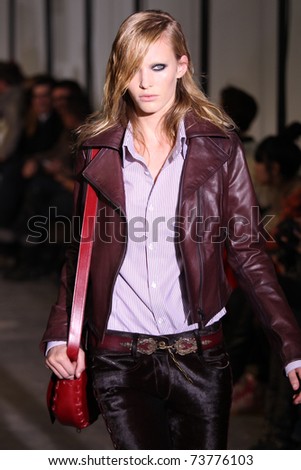 NEW YORK - FEBRUARY 15: Model Emily Baker walks the wooden runway at the DIESEL BLACK GOLD  Fall 2011 Collection presentation during Mercedes-Benz Fashion Week on February 15, 2011 in New York.