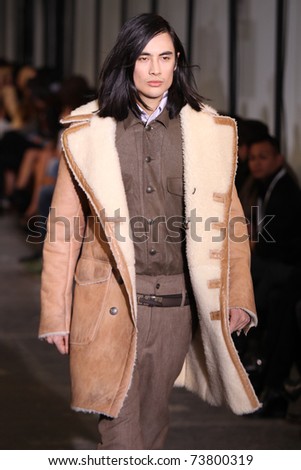 NEW YORK - FEBRUARY 15: Male model walks the wooden runway at the DIESEL BLACK GOLD Fall 2011 Collection presentation during Mercedes-Benz Fashion Week on February 15, 2011 in New York.