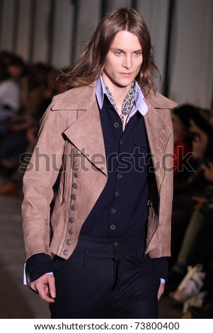 NEW YORK - FEBRUARY 15: Male model walks the wooden runway at the DIESEL BLACK GOLD Fall 2011 Collection presentation during Mercedes-Benz Fashion Week on February 15, 2011 in New York.