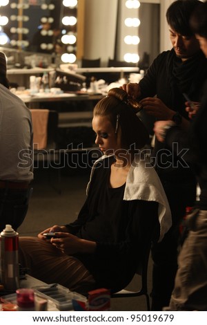 NEW YORK - FEBRUARY 12: Model gets hair done backstage at the A Detacher FW 2012 runway collection presentation during Mercedes-Benz Fashion Week on February 12, 2012 in New York.