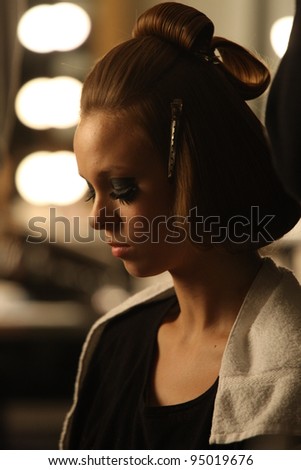 NEW YORK - FEBRUARY 12: Model gets hair done backstage at the A Detacher FW 2012 runway collection presentation during Mercedes-Benz Fashion Week on February 12, 2012 in New York.