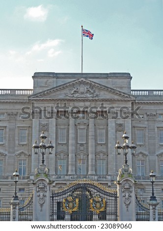 Facade of Buckingham Palace in London, England with the Union Jack flying showing the Queen is in residence