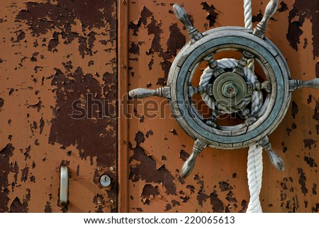 Old boat with a wood wheel on a dock. Horizontal orientation image.