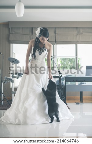 Portrait of a happy bride with a small dog / Vintage style