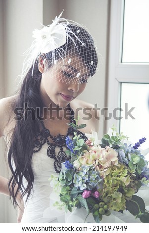 Beauty bride holding bouquet on in door. / Vintage style