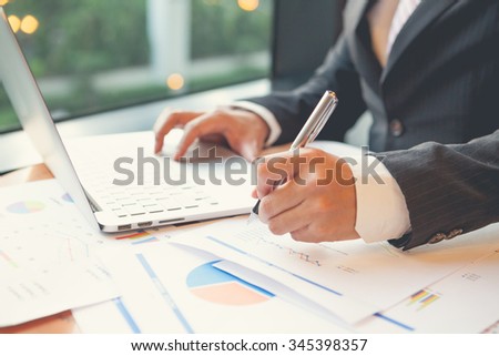 Young businessmen using Notebook and writing business plan at meeting in office