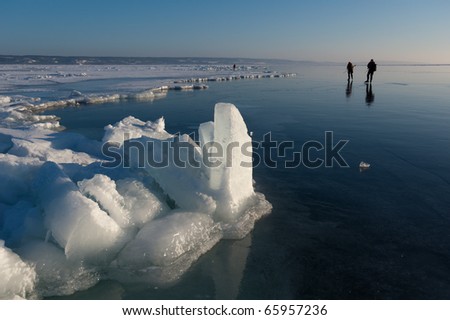 Scandinavian ice skaters on a large frozen lake.  Vaettern, Sweden.