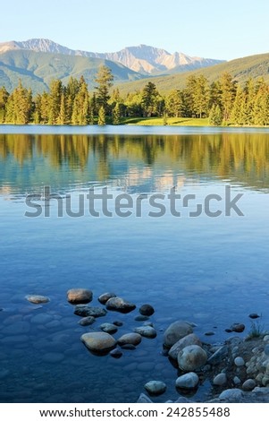 Calming Reflection of Mountains in Beautiful Blue Lake - Lac Beauvert, Jasper, Canada - UNESCO World Heritage