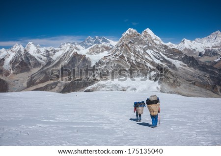 Porter carrying heavy loads in Himalayas of Nepal
