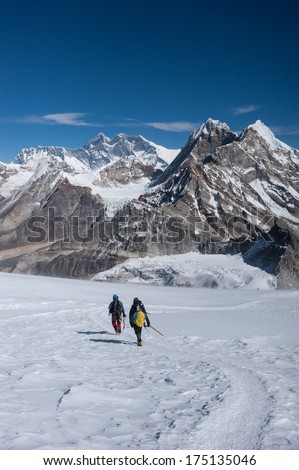 Mountaineers walking on snow with Mt. Everest, Himalayas of Nepal
