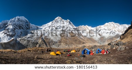 Annapurna, Nepal - Nov 27, 2013 : Unidentified trekking group at the base camp, with Annapurna range in background. Nepal has some of the best trekking and peak climbing in the world.