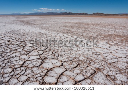 Flat saline desert, with dry and cracked ground in Uyuni, Bolivia.