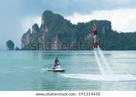 PHI PHI ISLAND, KRABI, THAILAND - MAY 6, 2014: An unidentified woman playing the new water sport at Phi Phi Don Island, a popular beach destination for tourists.