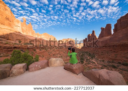 Tourist at viewpoint of Park Avenue in Arches National Park,Utah, USA