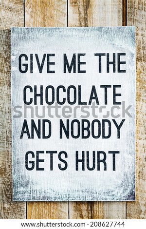 hand-painted motivational wooden vintage board on the rustic wooden background saying Give me the chocolate and nobody gets hurt hand-painted motivational wooden vintage board on the rustic wooden background saying Give me the chocolate and nobody gets hurt