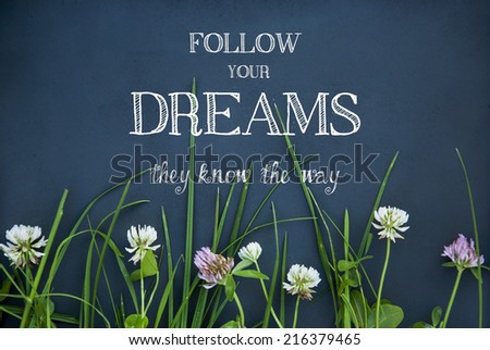 motivational quote FOLLOW YOUR DREAMS on black background with flowers
