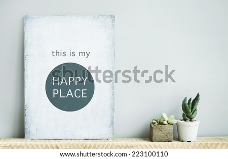 old wooden rustic poster with quote THIS IS MY HAPPY PLACE with succulents in concrete pots. Scandinavian style home decoration.