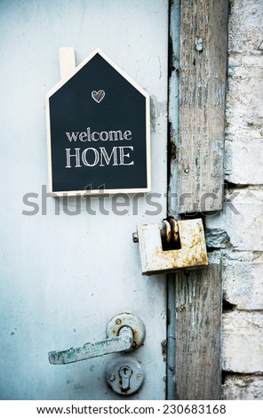 House Shaped Chalkboard sign on rustic blue door WELCOME HOME