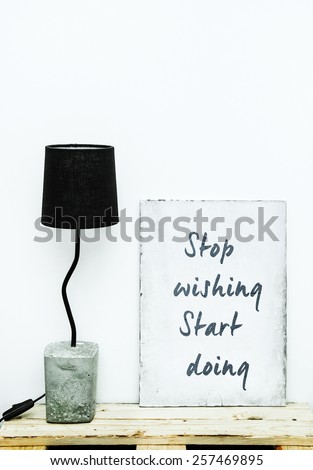 Motivational hipster frame board STOP WISHING START DOING   with diy concrete lamp. Scandinavian  style room interior