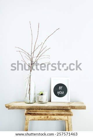 Motivational frame  BE YOU with glass bottles. Scandinavian hipster style room interior