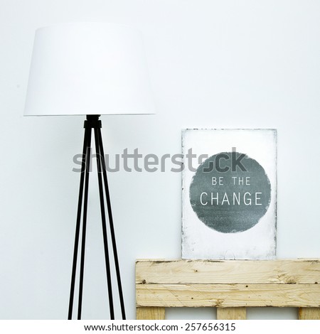 Motivational hipster board BE THE CHANGE with lamp. Scandinavian  style room interior