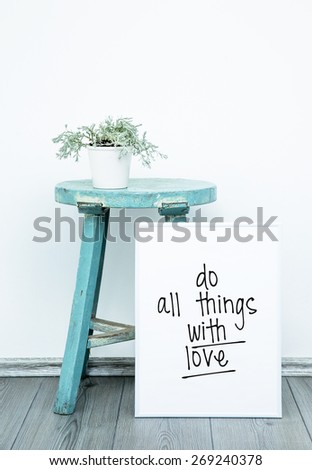 Motivational Poster quote DO THINGS WITH LOVE. Hipster scandinavian style room interior. White pot with flower on a blue coffee table