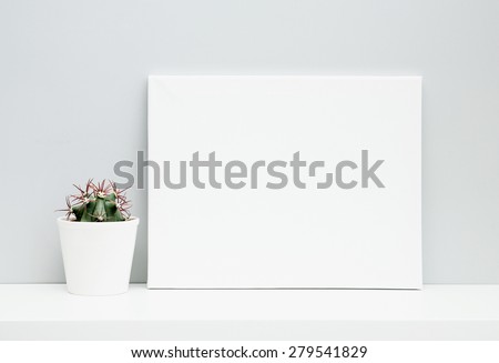 Hipster scandinavian style room interior. With place for text. White pot with cactus and frame on the shelf.