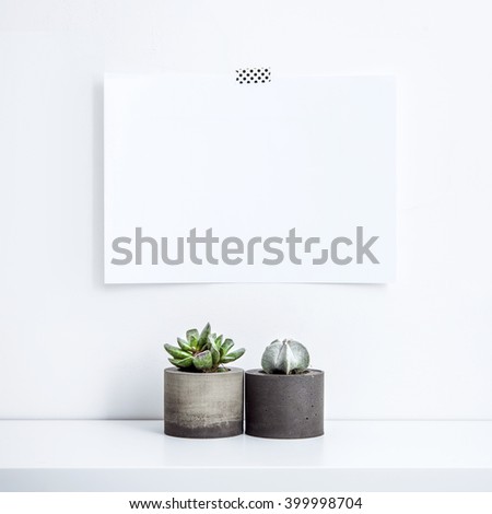 Scandinavian interior design. Hipster motivational set with  succulent in concrete planter. Note paper on the wall with quote BE HAPPY