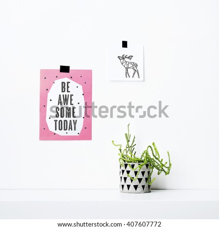 Hipster scandinavian home interior decoration. Paper notes on the white wall with deer drawing and quote BE AWESOME TODAY