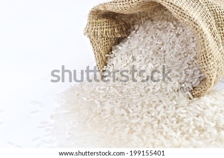 Rice Bag - close up, rice in a burlap bag on wooden surface