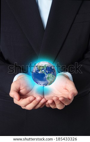 Businessman holds Earth in his hands, Elements of this image furnished by NASA
