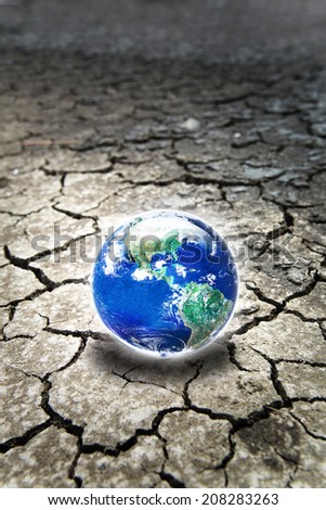 Earth on  dry cracked soil, Selective focus on Earth with shallow depth of field, Elements of this image furnished by NASA