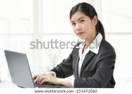 Woman Working at Computer In Contemporary Office