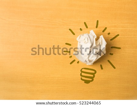 light bulb shape with paper ball on wood background, thinking differently concept, do not underestimate simple ideas concept