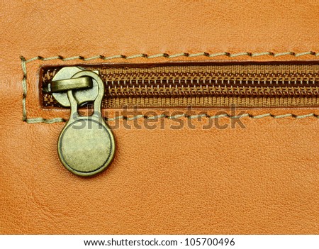 close-up of zip fastening on leather luggage