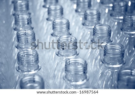 rows of plastic bottles on a factory production line