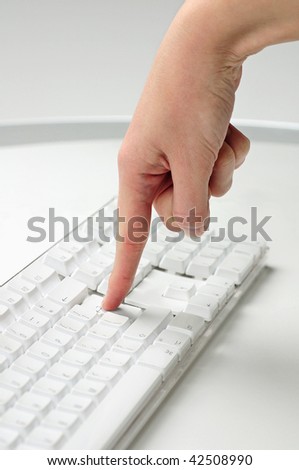 female finger pressing a computer key